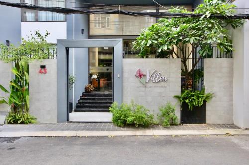 a entrance to a building with a sign that reads aloha at Cityhouse Villea in Ho Chi Minh City