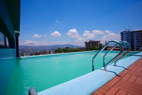 a swimming pool with a view of a city at An Oasis in the heart of Kigali in Kigali