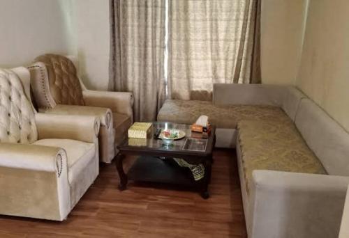 uma sala de estar com um sofá e uma mesa de centro em Waterstones Hotel em Naran