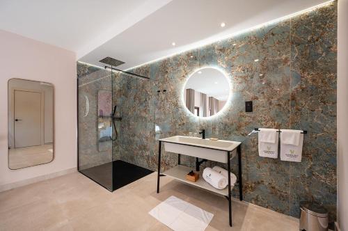 a bathroom with a sink and a mirror at Viewpoint Boutique Living in Xlendi