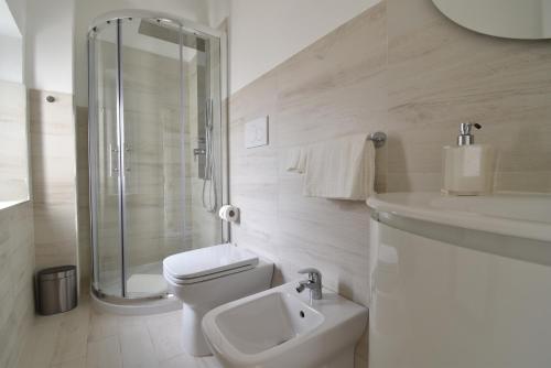 a bathroom with a toilet and a shower and a sink at Orsini Luxury Apartment in Florence