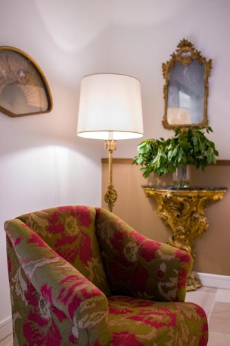 a living room with a chair and a lamp at Parco dei Principi in Sorrento