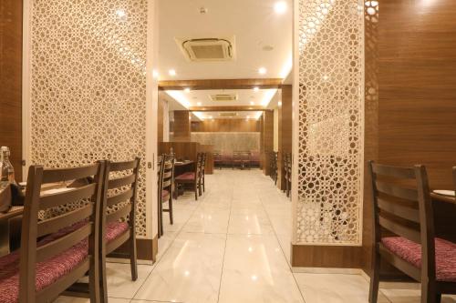 a corridor of a restaurant with chairs and tables at IRA by Orchid, Nashik in Nashik