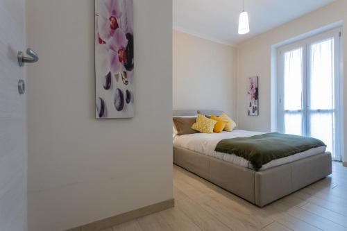 a white bedroom with a bed and a window at Modern House Santa Rita by Wonderful Italy in Turin