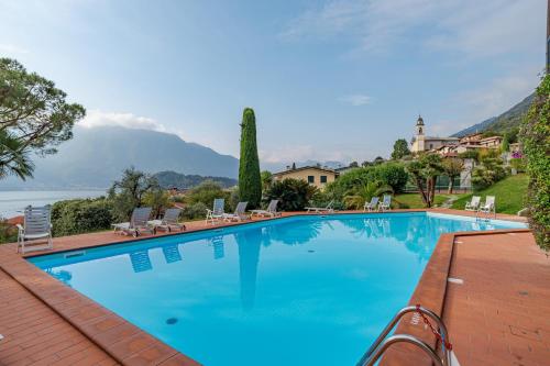 a large swimming pool with a view of the water at Brentano Giardino in Mezzegra