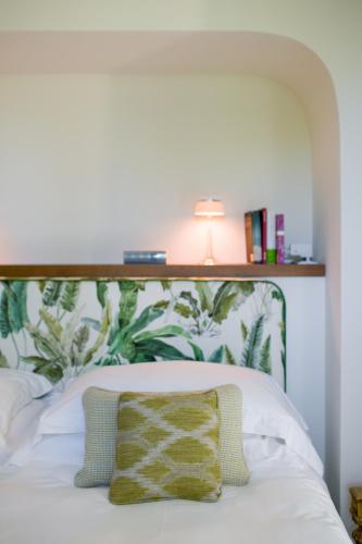a bed with a wooden headboard with a pillow on it at Parco dei Principi in Sorrento