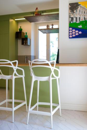 two white chairs and a table in a kitchen at Parco dei Principi in Sorrento