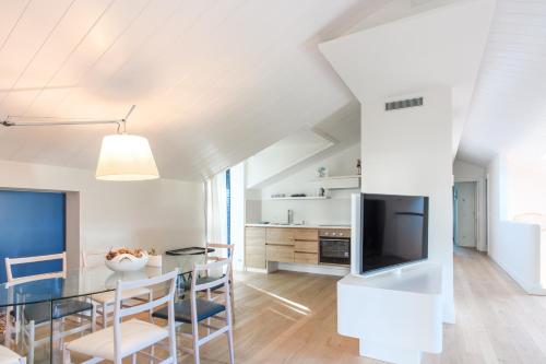 a dining room and kitchen with a table and a tv at Parco dei Principi in Sorrento
