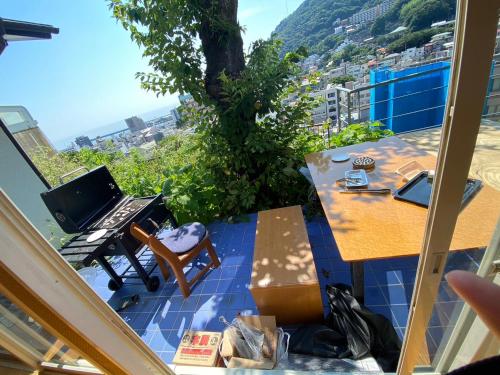 a balcony with a table and a view of a city at ヴィラマーレ熱海（Villa Mare Atami） in Atami