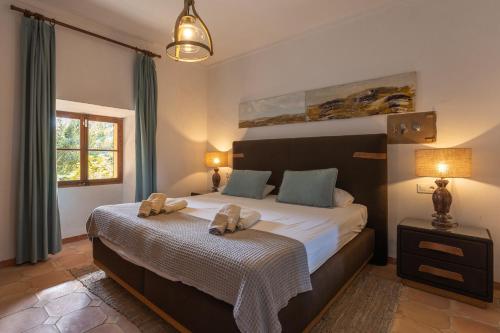 a bedroom with a large bed with two pillows on it at Buccara Casa Gran Daniel I in Pollença