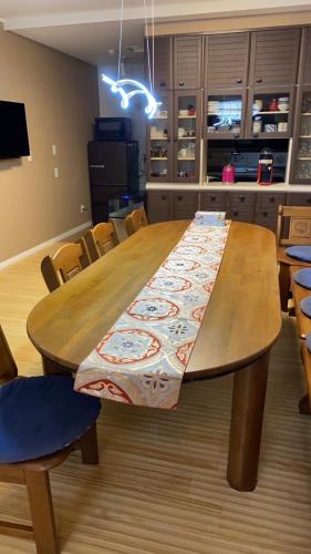 a large wooden table in a kitchen with chairs at ヴィラマーレ熱海（Villa Mare Atami） in Atami