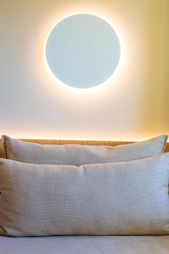 a light above a bed with a white pillow at Eurotel Altura in Altura