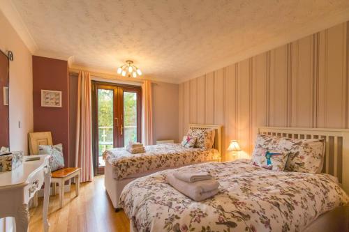 a bedroom with two beds and a window at Four Seasons in Norwich