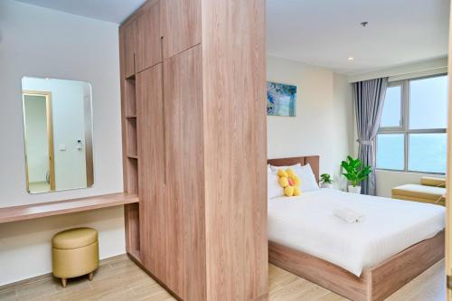 a bedroom with a large wooden partition with a bed at VIP THE SÓNG APARTMENT NEAR THE BEACH 5 STAR - FREE INFINITy in Vung Tau