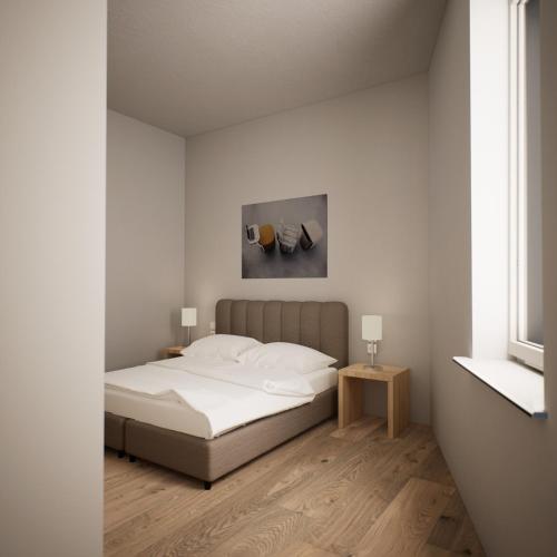 a bedroom with a bed and a painting on the wall at ADAPT Apartments Wetzlar in Wetzlar
