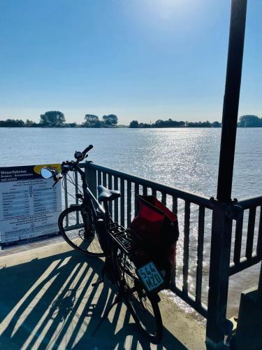 a bike parked on a pier next to a body of water at Kleine Burg Ovelgönne in Ovelgönne