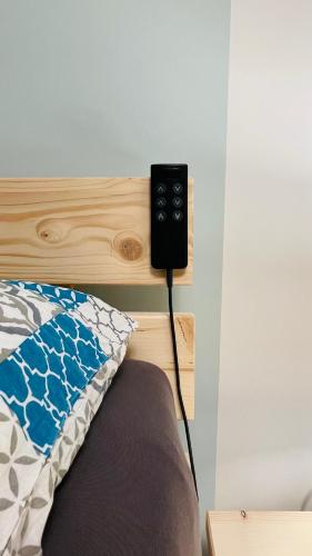 a video game controller attached to the headboard of a bed at Kleine Burg Ovelgönne in Ovelgönne