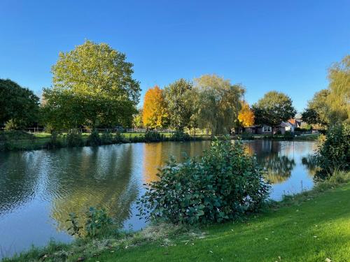 a view of a river with trees in the background at Kleine Burg Ovelgönne in Ovelgönne