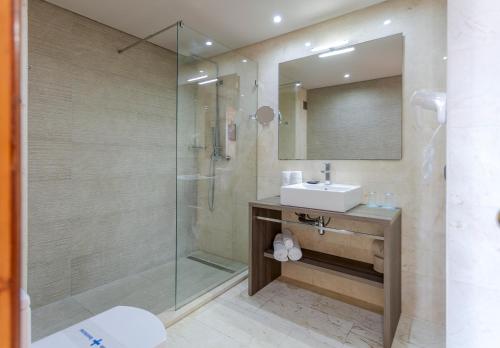 a bathroom with a sink and a shower at Marins Beach Club - Adults Only Hotel in Cala Millor