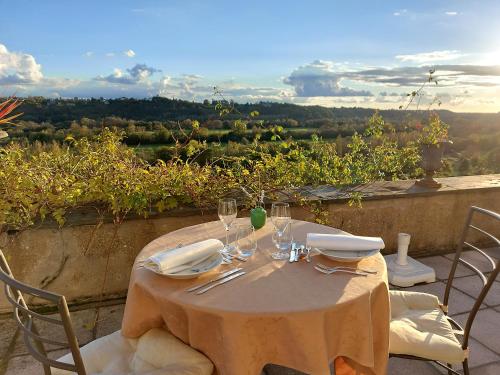 a table with wine glasses and napkins on a balcony at Château Haute Roche in Oudon
