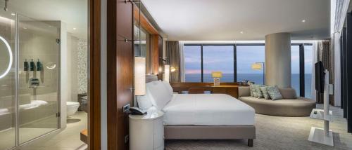 a hotel room with a bed and a bathroom at Hilton Batumi in Batumi