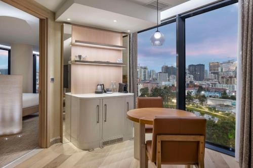 a kitchen and dining room with a view of a city at Hilton Batumi in Batumi