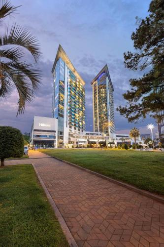 two tall buildings in a city with a park at Hilton Batumi in Batumi