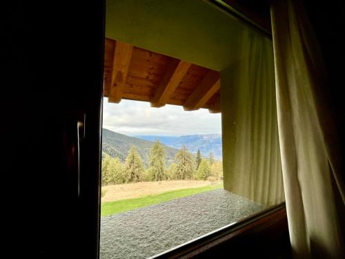 a window view of a mountain view from a house at Hotel La Chance in Pila