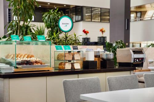 a bakery with a display of pastries on a counter at Embassy Suites by Hilton West Palm Beach Central in West Palm Beach