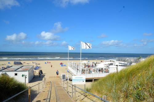 a view of a beach with people on it at SummerTime Bergen aan Zee in Bergen aan Zee