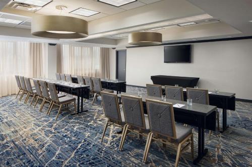 a conference room with tables and chairs and a podium at Embassy Suites by Hilton West Palm Beach Central in West Palm Beach