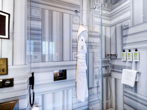 a bathroom with a shower with a glass door at The Galata Istanbul Hotel MGallery in Istanbul