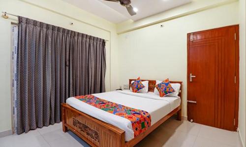 a bedroom with a large bed and a window at Via Kings Suites in Bengaluru