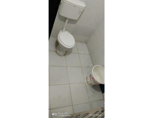 a bathroom with a white toilet in a room at Excel Hotel, Somnath in Somnath