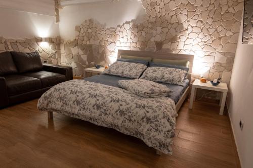 a bedroom with a bed and a couch at tulipano rosso in Bari