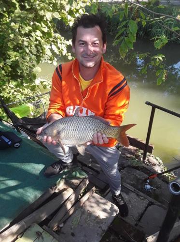a man holding a fish in his hands at Alexander apartman in Gyula