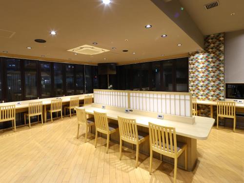 a conference room with a long table and chairs at Dormy Inn Tokyo Hatchobori - Natural Hot Spring in Tokyo