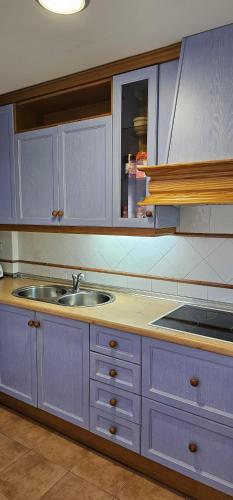 a kitchen with white cabinets and a sink at MARINA BEACH FRONT in La Herradura