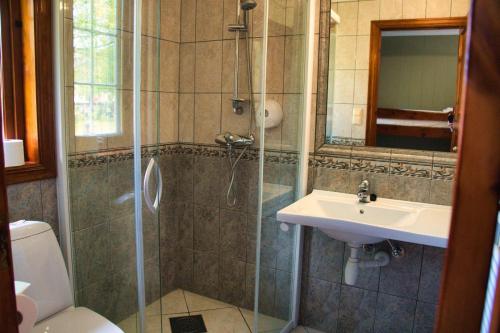 a bathroom with a shower and a sink at Sølvgarden Motell in Rysstad