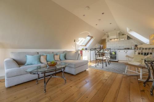 a living room with a couch and a table at Miller's Loft in Erpingham