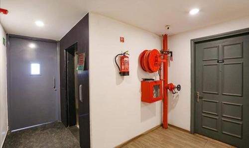 a room with a door and a fire hydrant at FabExpress Urban Residency Model Town in New Delhi