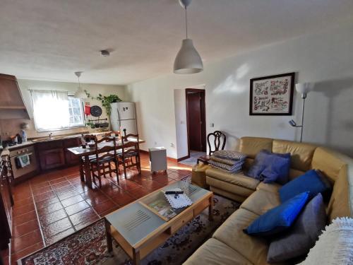 a living room with a couch and a table at Casa do Lima Alojamento Local Registo134359.AL in Brandara