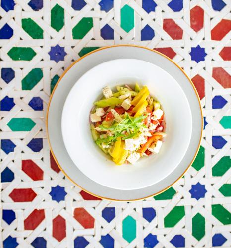 a plate of food on a table with a salad at RIAD GOLD in Azrou