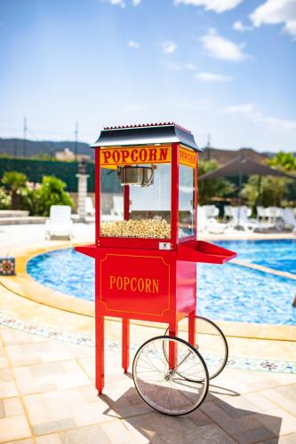 a red food stand on a bike next to a pool at RIAD GOLD in Azrou