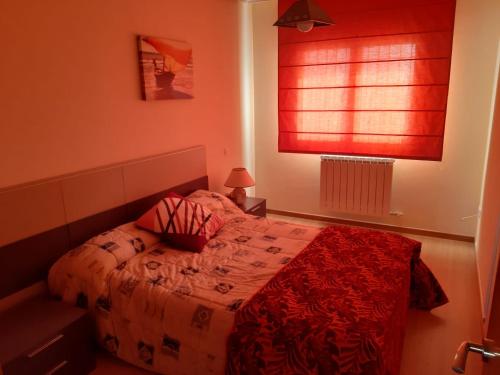 - une chambre avec un lit et une fenêtre rouge dans l'établissement APARTAMENTO EN ALESANCO-LARIOJA, à Alesanco