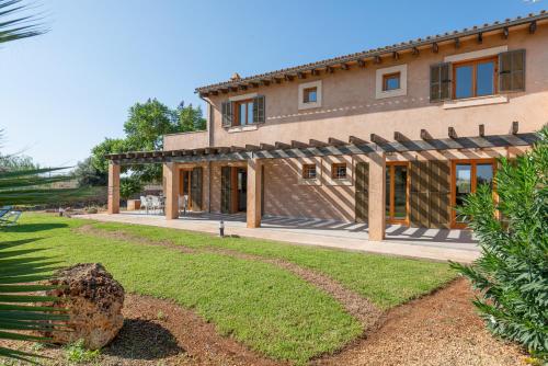 a large house with a lawn in front of it at Es Regalo - Pérgola in Porto Cristo