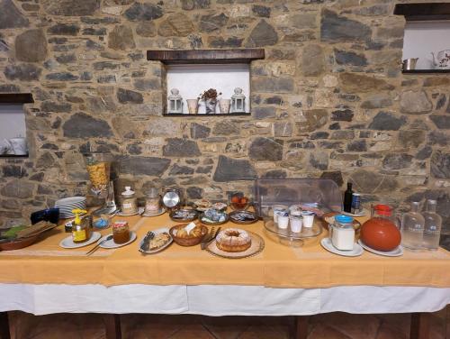 a table with food on it in a stone wall at Agriturismo a Canonica in Garlenda