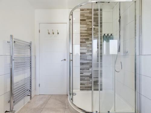a shower with a glass door in a bathroom at Cosy and luxurious house for 10 guests in Darwen in Darwen