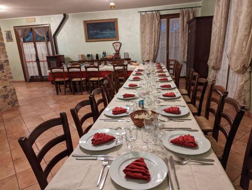 a long table with plates of food on it at Agriturismo a Canonica in Garlenda