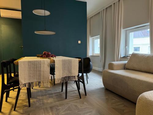 a living room with a table and a couch at URBAN Penthouse FREE parking i rowery in Poznań